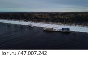 Aerial view of a barge on a winter river with ice. Стоковое фото, фотограф David Kashakhi / Фотобанк Лори