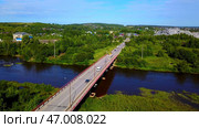 Arial view of a small town crossed by a river with a bridge. Стоковое фото, фотограф David Kashakhi / Фотобанк Лори