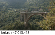 Stone bridge in green mountains in European style. Стоковое фото, фотограф David Kashakhi / Фотобанк Лори