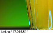 Yellow alcohol drink inside transparent glass. Стоковое фото, фотограф David Kashakhi / Фотобанк Лори