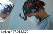 Surgeon with binocular loupe, professional medical equipment. Стоковая иллюстрация, иллюстратор David Kashakhi / Фотобанк Лори