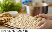 Passover preparation with matzah crackers and handmade matzo balls. Стоковое AI-изображение, AI-художник Анастасия Золотницкая / Фотобанк Лори