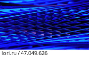 Metallic grid of narrow stripes forming rotating tube shaped blue figure. Стоковое фото, фотограф David Kashakhi / Фотобанк Лори