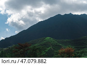 The Lush Green Mountains Stand Tall Under a Beautifully Cloudy Sky, Awaiting Adventurers. Стоковое фото, фотограф David Kashakhi / Фотобанк Лори
