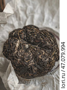 Experience the richness of Compressed Puerh Tea presented in its Natural Wrapping form. Стоковое фото, фотограф David Kashakhi / Фотобанк Лори
