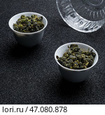 An Elegant Presentation of Oolong Tea in Beautiful Traditional Tea Cups for Everyones Enjoyment. Стоковое фото, фотограф David Kashakhi / Фотобанк Лори