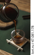 Pouring a Warm Brew Enjoying a Teatime Moment Captured in Beautiful Focus and Detail. Стоковое фото, фотограф David Kashakhi / Фотобанк Лори