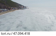 Listvyanka village, a popular tourist destination on the shores of Lake Baikal. Tourists walk on the spring ice, a hovercraft transports travelers. Стоковое видео, видеограф Виктория Тельминова / Фотобанк Лори