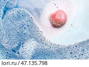 Розовая ванная бомба растворяется в синей воде. Стоковое фото, фотограф Pixel_shot / Фотобанк Лори