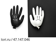 Различные надутые перчатки с грустными и счастливыми улыбками на черно-белом фоне. Стоковое фото, фотограф Pixel_shot / Фотобанк Лори