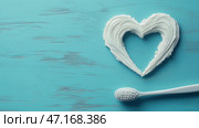 Heart shape formed by smooth white toothpaste on a blue background. Стоковое AI-изображение, AI-художник Katsiaryna Repich / Фотобанк Лори