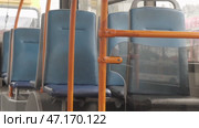 Blue seats and orange handrails in public transport in a trolleybus. Стоковое видео, видеограф Дмитрий Нечаев / Фотобанк Лори