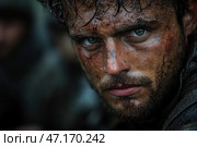 Close-up of a man with a dirty and sweaty face. His skin is covered with small scratches, streaks of dirt and drops of moisture. The man's gaze is tense, his eyes are light in color, as if peering intently at the viewer. His hair is wet and disheveled, and his beard and moustache are carelessly overgrown. The atmosphere around is gloomy and harsh, the blurred background hints at the presence of other people or difficult environmental conditions. The clothes are dark, possibly military or tourist, soaked in moisture and dirt. Стоковое AI-изображение, AI-художник Анна Кривицкая / Фотобанк Лори