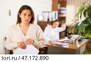 Unhappy woman standing in office after reprimand from chief. Стоковое фото, фотограф Яков Филимонов / Фотобанк Лори