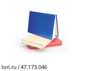 Stack of red, yellow and blue books isolated on a white background. Стоковое фото, фотограф Елена  Попкова / Фотобанк Лори