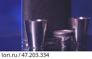 The rotation of a metal flask for alcohol. Стоковое видео, видеограф Потийко Сергей / Фотобанк Лори