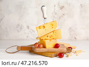 Доска со свежим сыром и ножом на белом фоне. Стоковое фото, фотограф Pixel_shot / Фотобанк Лори