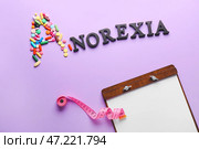 Слово ANOREXIA, таблетки, буфер обмена и рулетка на цветном фоне. Стоковое фото, фотограф Pixel_shot / Фотобанк Лори
