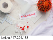 Композиция с кактусом, туалетной бумагой и словом ГЕМОРРОЙ на светлом фоне. Стоковое фото, фотограф Pixel_shot / Фотобанк Лори