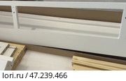 Wooden elements for assembling an ottoman. Self-assembly furniture. Стоковое видео, видеограф Vadzim Yakubovich / Фотобанк Лори