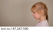 Profile view of serious pensive young girl with braided hair. Stubborn child. Copy space. Стоковое AI-изображение, AI-художник Алла Чесноковва / Фотобанк Лори