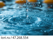 The moment a drop of water falls into the water surface. The impact creates a spectacular splash with small drops hanging in the air. The surface of the water is rippled and shimmers with shades of blue, creating a feeling of freshness and dynamics. This is macro photography, allowing you to see the smallest details of the water's movement. The background is blurred, which emphasizes the central element - the falling drop and its interaction with water. Стоковое AI-изображение, AI-художник Анна Кривицкая / Фотобанк Лори