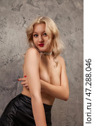 Blonde Beauty Poses in a Studio Setting With a Modern Artistic Flair and Enticing Allure. Стоковое фото, фотограф Aleksandr Golubev / Фотобанк Лори
