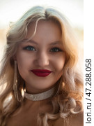 Radiant Young Woman With Blonde Hair Poses Elegantly in a Stylish Outdoor Studio Setting. Стоковое фото, фотограф Aleksandr Golubev / Фотобанк Лори