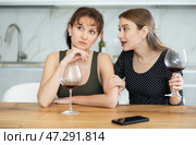 Sad woman sits silently in kitchen, friend sympathize and comfort her. Стоковое фото, фотограф Яков Филимонов / Фотобанк Лори