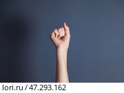 Expressive Hand Gesture Symbolizes Strength and Resilience in a Creative Studio Setting. Стоковое фото, фотограф Aleksandr Golubev / Фотобанк Лори