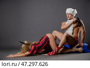 Couple engages in playful roleplay with costumes in a studio setting. Стоковое фото, фотограф Гурьянов Андрей / Фотобанк Лори