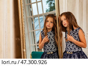 Seven-year-old Girl Model Poses in Stylish Outfit While Reflecting on Her Beauty in the Mirror. Стоковое фото, фотограф Aleksandr Golubev / Фотобанк Лори