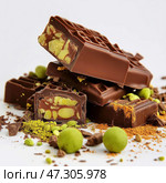 Luxury chocolate candies with pistachio filling and gold dust, gourmet confectionery assortment with dark chocolate pieces, artisan pralines with green filling on white background, fancy dessert. Стоковое AI-изображение, AI-художник Сергей Тимофеев / Фотобанк Лори