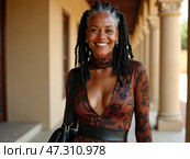 A Confident Woman With Long, Dreadlocked Hair Smiles Warmly While Wearing an Elegant Dress in an Outdoor, Sunlit Walkway. Стоковое AI-изображение, AI-художник Sergey Grishin / Фотобанк Лори