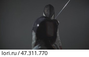 Fencing - two person in a white protective suits and helmets training with the swords in the studio. Стоковое видео, видеограф Константин Шишкин / Фотобанк Лори