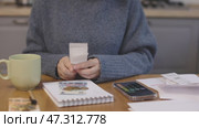 female hands in blue warm clothes look through shop receipts bills calculate. Стоковое видео, видеограф Olesia Kondrateva / Фотобанк Лори
