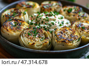A delicious dish of baked or fried artichoke, cut into large pieces and beautifully arranged in a circle in a ceramic bowl. The center of the dish is a creamy dressing or sauce (possibly based on yogurt or sour cream), decorated with herbs and spices. The artichoke leaves are browned until golden, generously sprinkled with fresh herbs - probably parsley. The overall atmosphere of the image is coziness, home gastronomy and health. Such a dish can be imagined as part of a vegetarian or Mediterranean lunch. Стоковое AI-изображение, AI-художник Анна Кривицкая / Фотобанк Лори