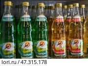 Shelf in store with glass bottles soda of different flavors. Tarragon and Pinocchio flavor, Chernogolovka Russian brand. Редакционное фото, фотограф Екатерина Якименко / Фотобанк Лори