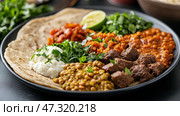 Eritrean injera platter featuring colorful lentil and meat stews, served with fresh herbs and lime in warm natural light. Стоковое AI-изображение, AI-художник 123 12 / Фотобанк Лори