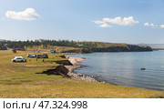 BAIKAL LAKE, OLKHON ISLAND, KHARANTSY VILLAGE, IRKUTSK REGION, RUSSIA - August 04, 2024:  People came to beach of Small Sea, set up tent camps, swim, sunbathe, actively relax with their families. Редакционное фото, фотограф Виктория Катьянова / Фотобанк Лори
