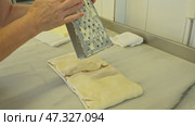 Handcrafted pastry preparation in a cozy kitchen setting with a focus on grated cheese. Стоковое видео, видеограф Сергей Толмачёв / Фотобанк Лори