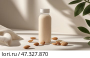 Almond milk bottle surrounded by nuts in a minimalist setting. Прозрачная бутылка миндального молока стоит вертикально на гладкой поверхности в окружении рассыпанных орехов. Мягкий естественный свет подчеркивает кремовую текстуру и минималистичный дизайн, создавая безмятежную атмосферу. Стоковое AI-изображение, AI-художник Katsiaryna Repich / Фотобанк Лори