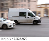 White cargo and passenger van GAZelle Next in the city street in motion. Редакционное фото, фотограф Константин Григорьев / Фотобанк Лори