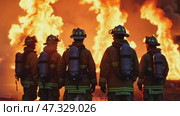 A group of firefighters stands together, facing a massive wildfire as flames rage in the background. They are geared up and ready to tackle the challenging blaze. Стоковое AI-видео, аниматор Sergey Grishin / Фотобанк Лори