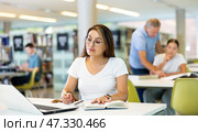 Young female hispanic student studying with a laptop. Стоковое фото, фотограф Яков Филимонов / Фотобанк Лори