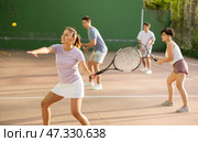 Woman playing frontenis with partners at sunny day, healthy lifestyle concept. Стоковое фото, фотограф Яков Филимонов / Фотобанк Лори