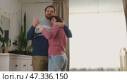 Emotional Dance. Middle-aged Couple Dancing Together Embrace at Home. Mature Couple dancing bonding, smiling and moving to the rhythm in a romantic vibe enjoying their anniversary. Active relationship. Стоковое видео, видеограф Марина Демидюк / Фотобанк Лори