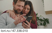 Mature couple hugging hugging each other kissing at home bedroom. Intimate Moment. Tender embrace shared between a loving middle age man and woman, husband and wife. Deep love. Low key, cinematic. Стоковое видео, видеограф Марина Демидюк / Фотобанк Лори