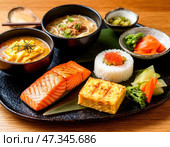 Тарелка с разнообразными блюдами восточной кухни, включая суши, рис и овощи. Стоковое AI-изображение, AI-художник Ярославский Максим / Фотобанк Лори