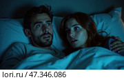 In a darkened bedroom illuminated by a blue light, a couple appears startled as they gaze at something off-screen, sharing an emotional moment under the covers. Стоковое AI-изображение, AI-художник Sergey Grishin / Фотобанк Лори